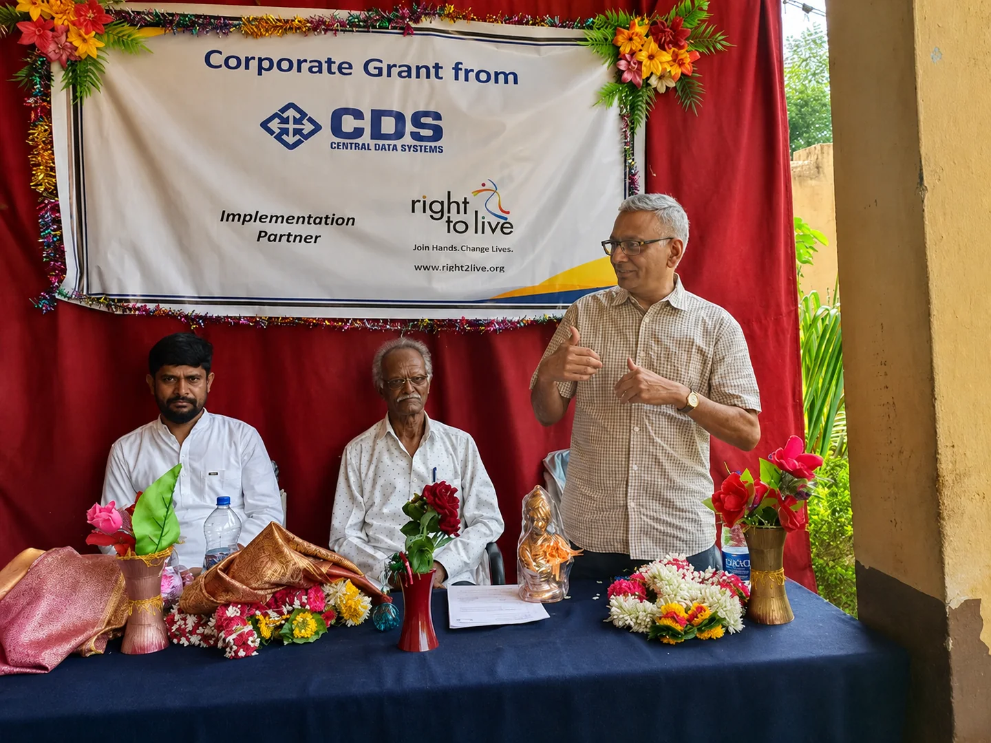 A CDS corporate grant presented at a community event, alongside the Right to Live implementation partner.