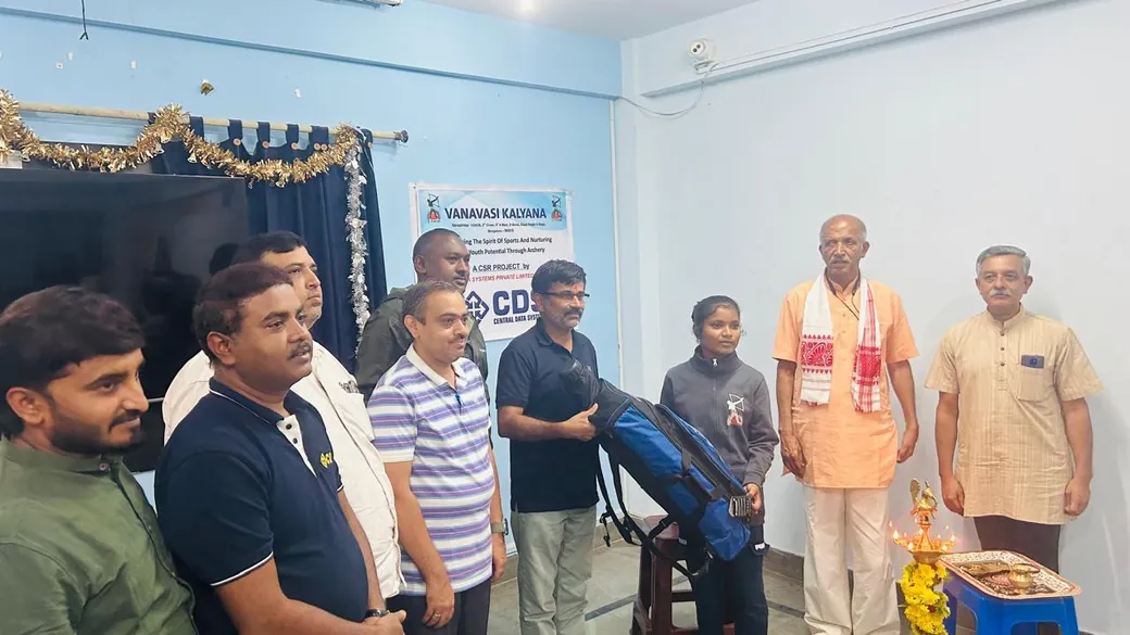 A tribal student receives a CDS-donated archery kit at a Vanavasi Kalyana handover.